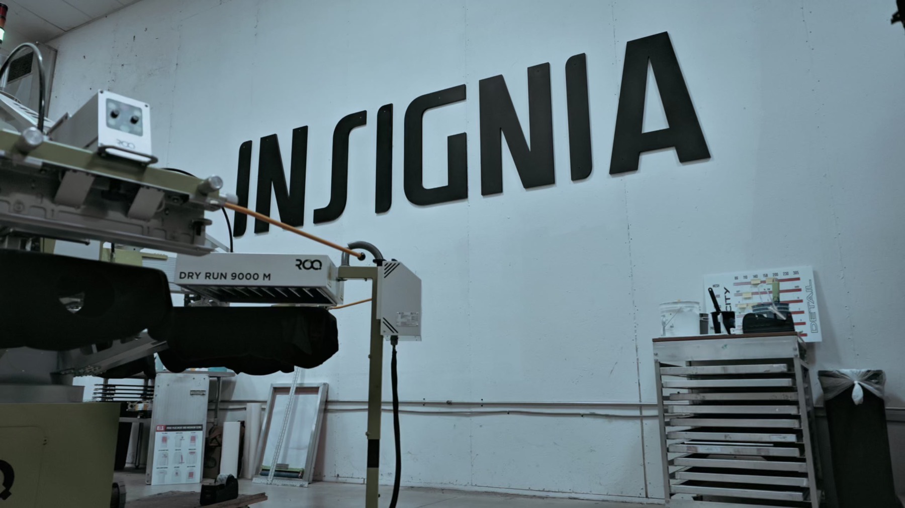 Inside the Insignia Screen Printing shop with the automatic press